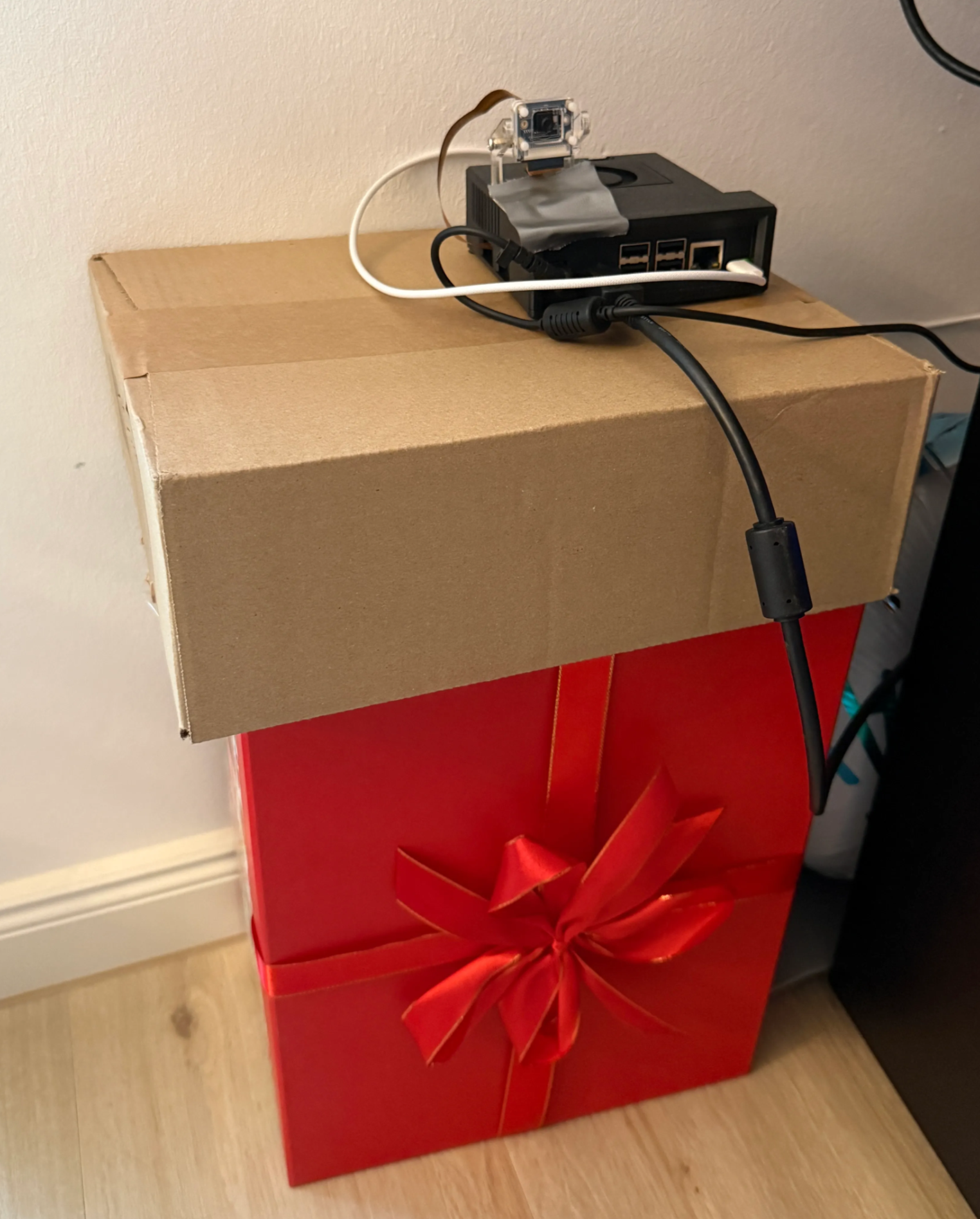 NVIDIA Jetson Orin Nano mounted on cardboard boxes for posture monitoring from side angle